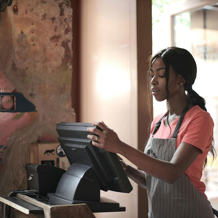 Cashier in a store looking at register